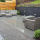 A contemporary granite patio and retaining wall