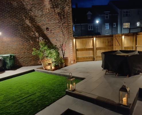 Small town garden with paving and artificial grass