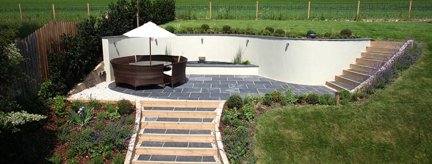 A sunken seating area with curved retaining wall and steps